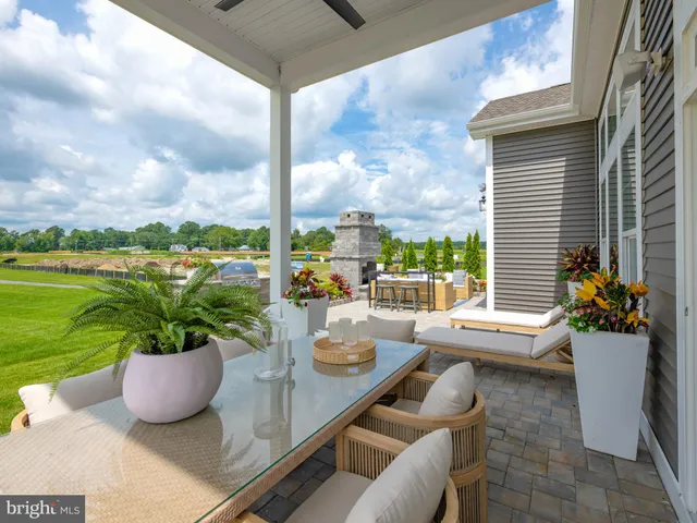 a view of a balcony with chairs and a potted plant