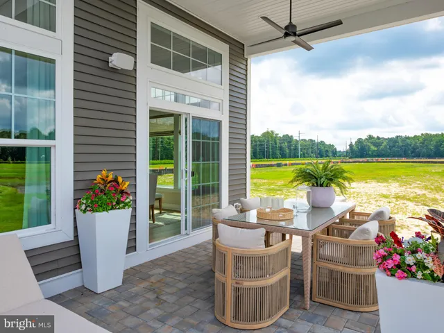 a view of a chairs and table in the patio and a ocean view