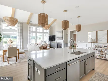 a kitchen with stainless steel appliances granite countertop a sink and a refrigerator