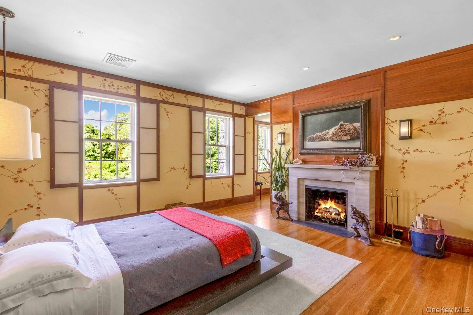 120 Ridge Road Tuxedo Park, NY 10987 - Photo 29 of 50 Bedroom with a warm lit fireplace, wood finished floors, and recessed lighting