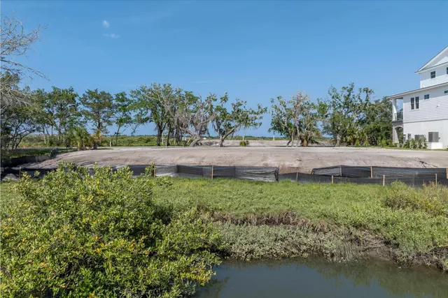a view of a yard with wooden fence