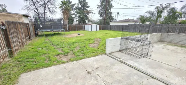 a view of a house with a yard and a tree