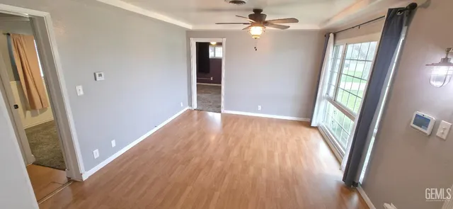 wooden floor in an empty room with a window