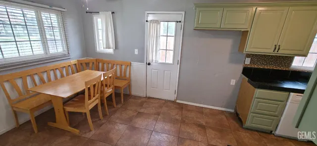 a view of a dining room with furniture and a window