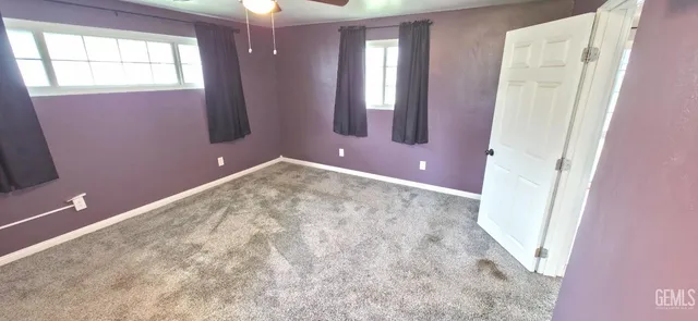 a view of a livingroom with wooden floor and window