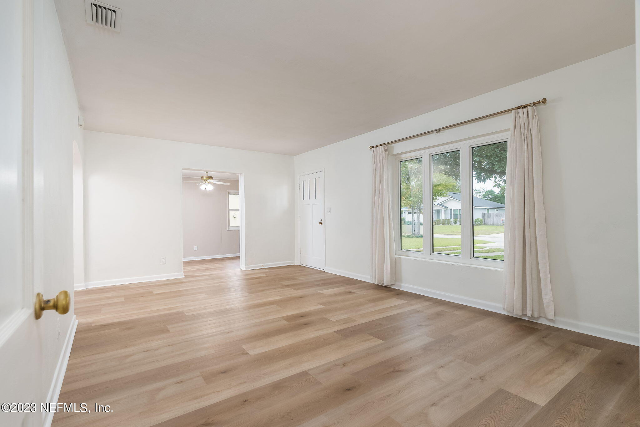 6236 Suwanee Road Jacksonville, FL 32217 - Photo 11 of 38 an empty room with window and wooden floor