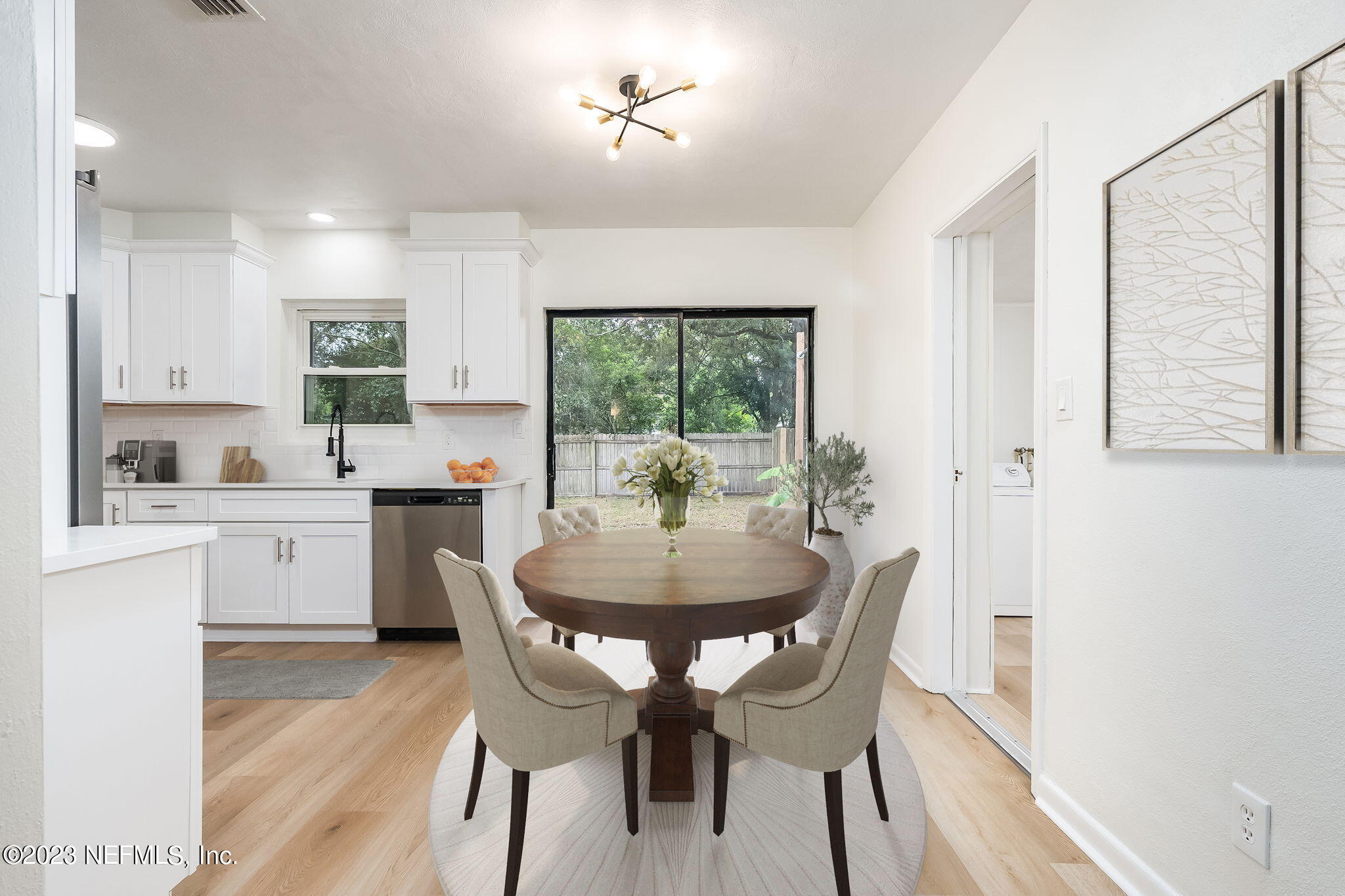 6236 Suwanee Road Jacksonville, FL 32217 - Photo 16 of 38 a kitchen with a dining table chairs and refrigerator
