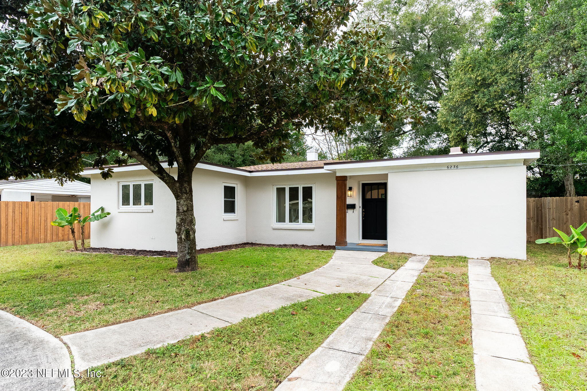 6236 Suwanee Road Jacksonville, FL 32217 - Photo 3 of 38 a front view of a house with a yard and trees