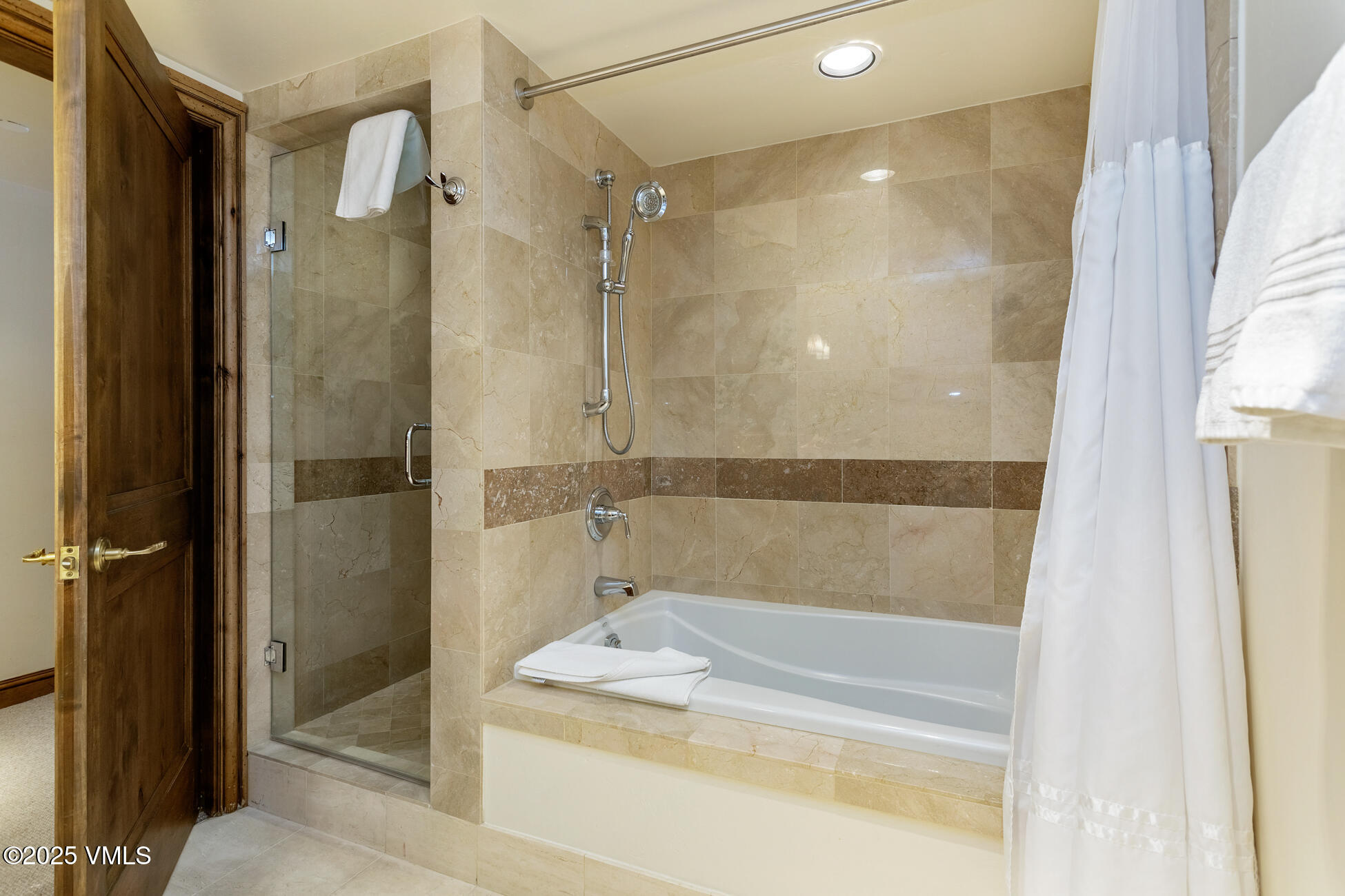 352 East Meadow Drive, Unit J Vail, CO 81657 - Photo 16 of 47 a bathroom with a bathtub and a shower