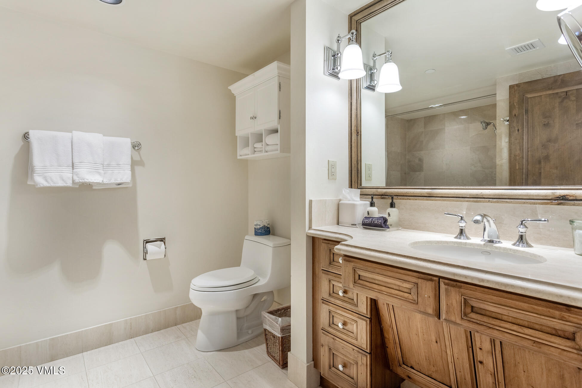 352 East Meadow Drive, Unit J Vail, CO 81657 - Photo 17 of 47 a bathroom with a toilet sink and mirror