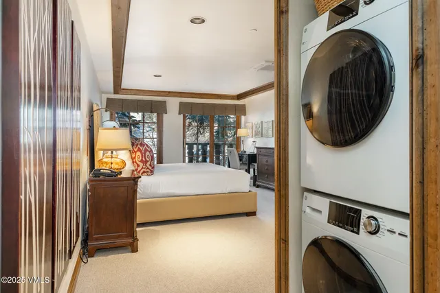 a bedroom with a large bed and a window