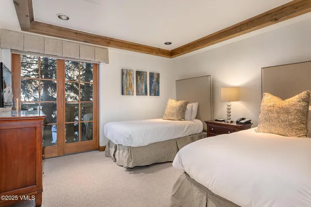 a bedroom with bed and wooden floor