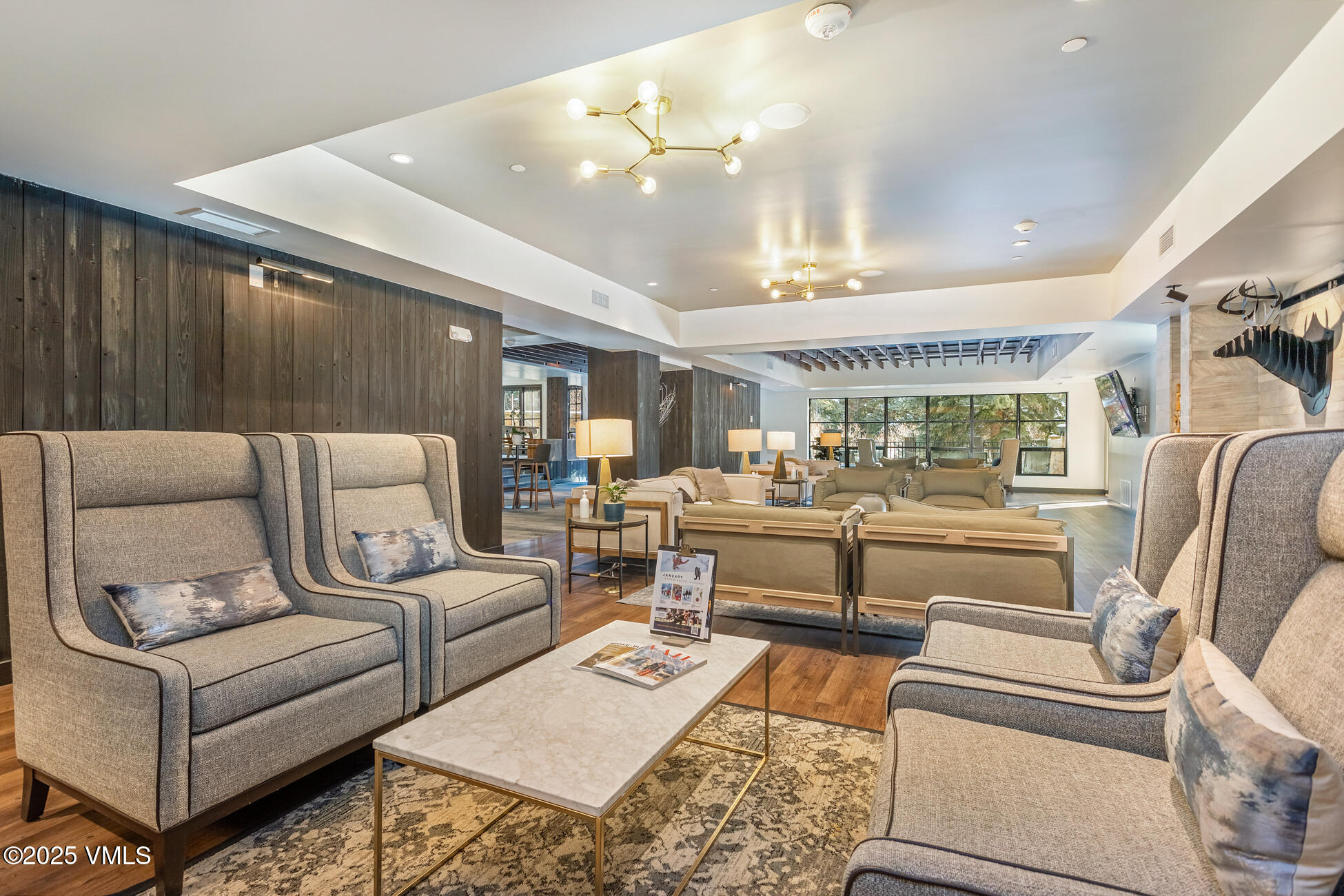 352 East Meadow Drive, Unit J Vail, CO 81657 - Photo 41 of 47 a living room with furniture and a chandelier
