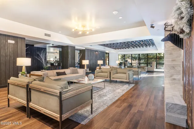 a dining hall with stainless steel appliances a dining table and chairs with wooden floor