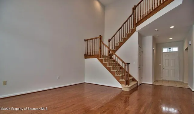 a view of an entryway with wooden floor