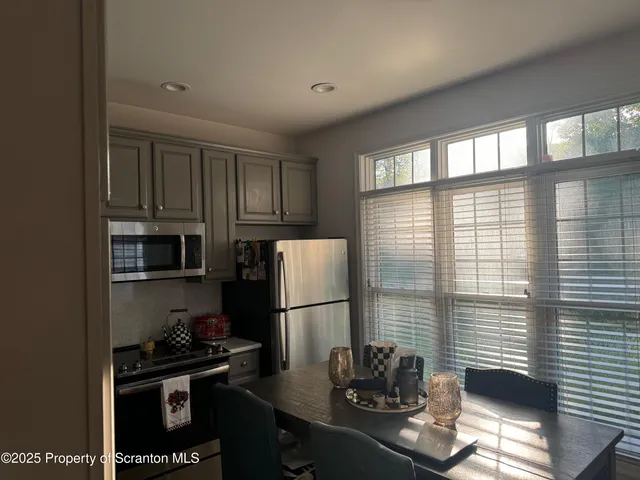 a kitchen with a sink a refrigerator and a stove