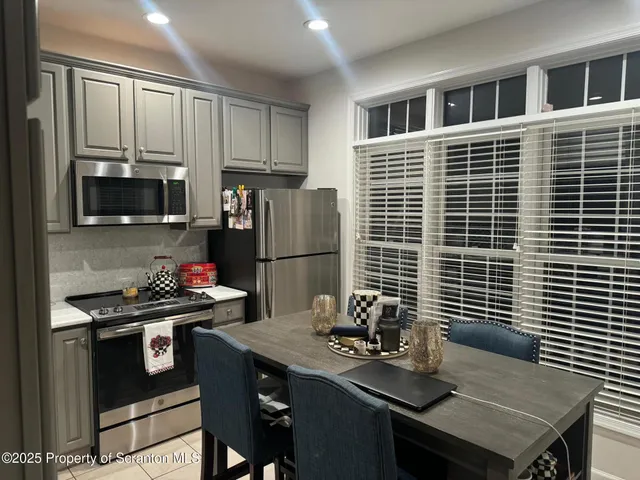 a kitchen with a sink stainless steel appliances and cabinets