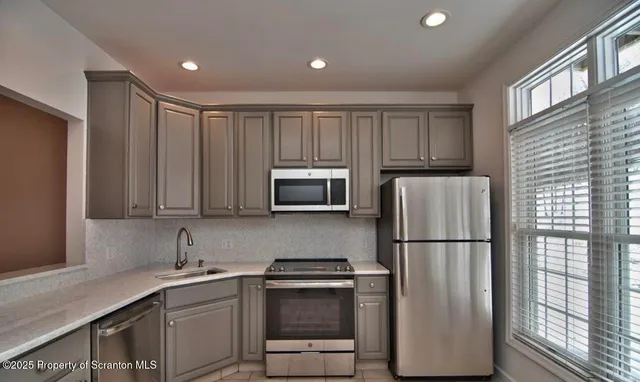 a kitchen with a refrigerator sink and microwave