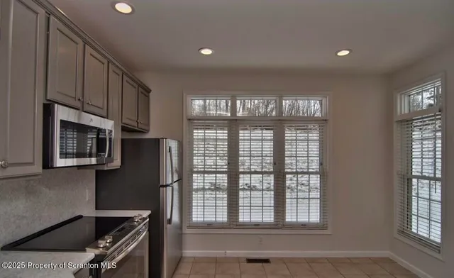 a kitchen with stainless steel appliances granite countertop a stove and a refrigerator