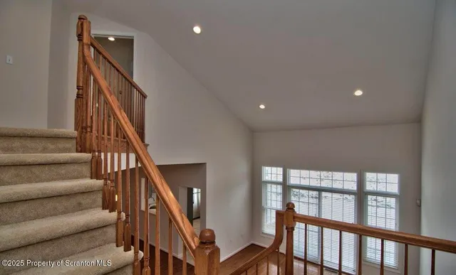 a view of entryway with wooden floor and stairs