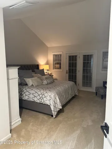 a bedroom with a large bed and a couch