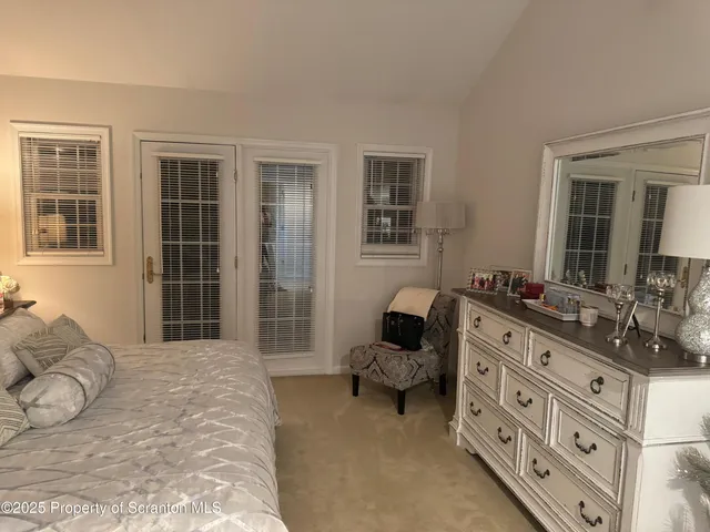 a spacious bedroom with furniture and a window