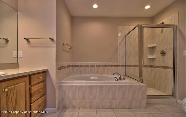 a bathroom with a bathtub and shower
