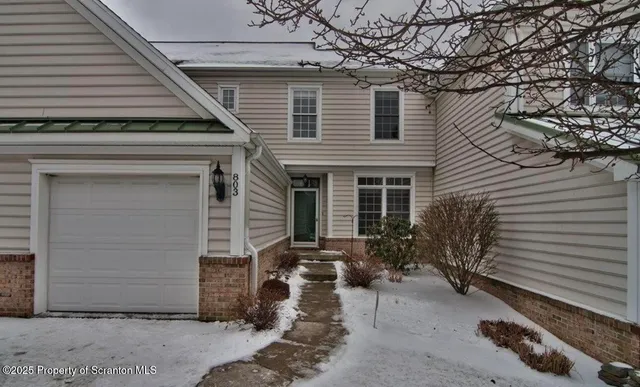 a backyard of a house with outdoor seating