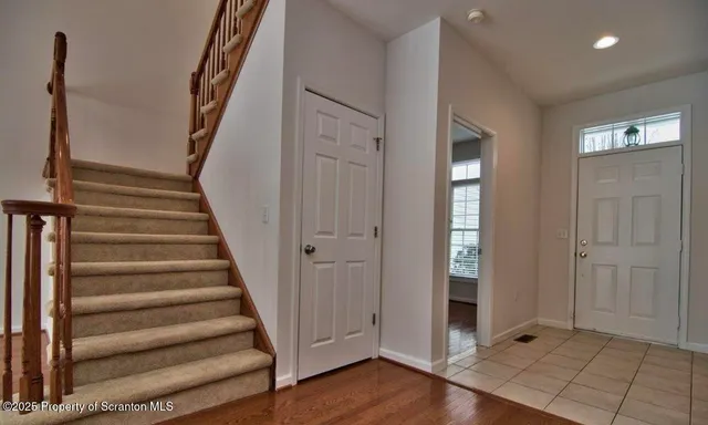a view of an entryway with wooden floor