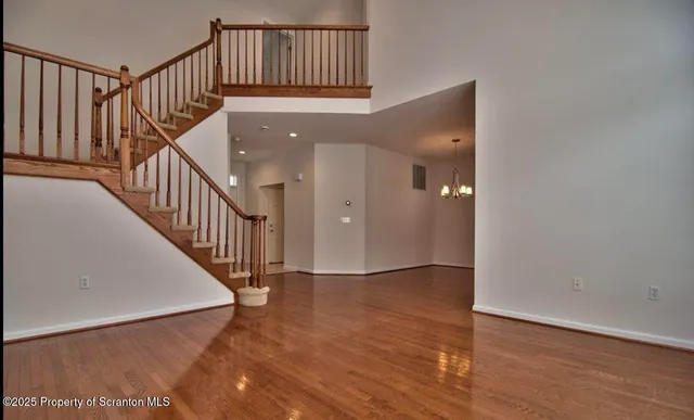 a view of staircase with railing and a rug
