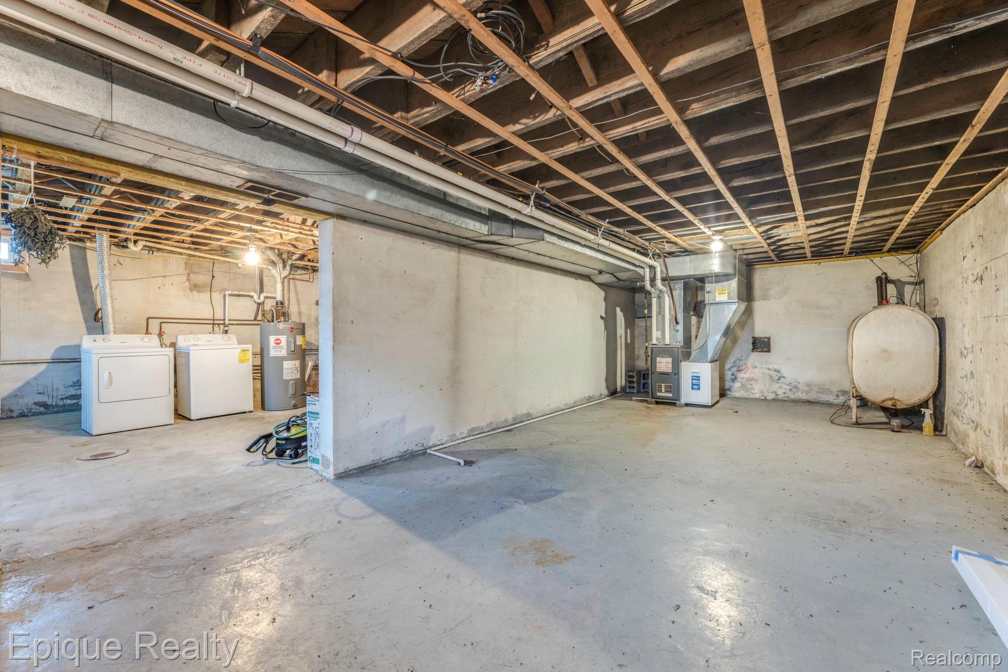 10091 North Genesee Road Mount Morris, MI 48458 - Photo 17 of 35 Unfinished basement featuring concrete walls and exposed ceiling joists