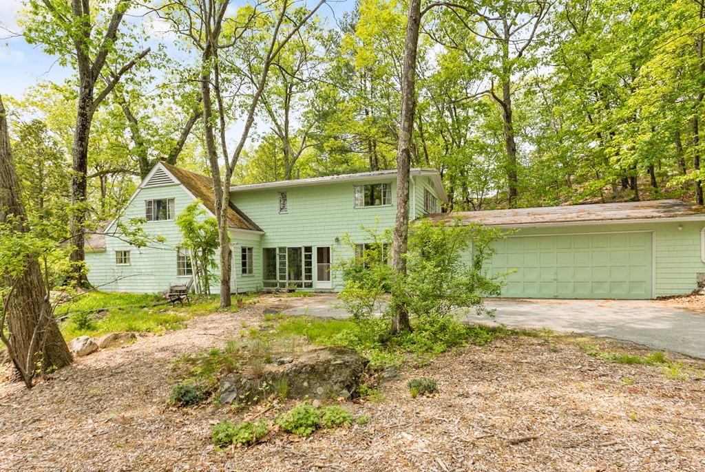 73 Old County Road Lincoln, MA 01773 - Photo 1 of 15 a front view of a house with garden