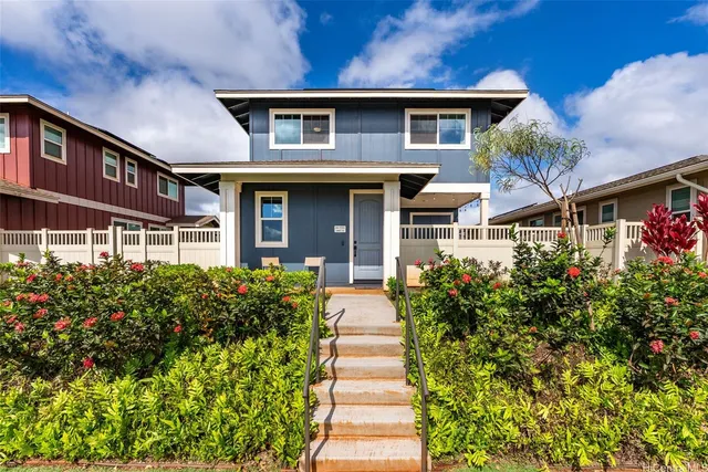 a front view of a house with a yard and fountain