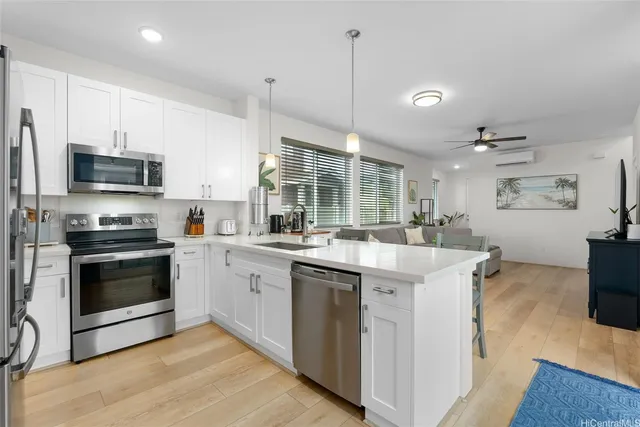 a kitchen with kitchen island a stove a sink and a refrigerator