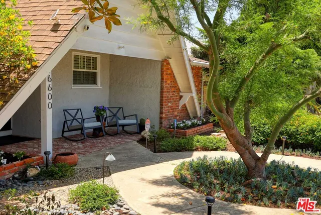 a backyard of a house with barbeque oven