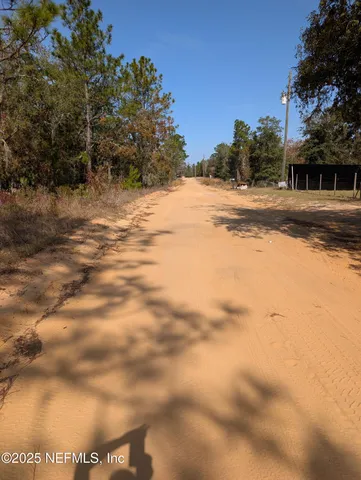 a view of a yard with snow on the road