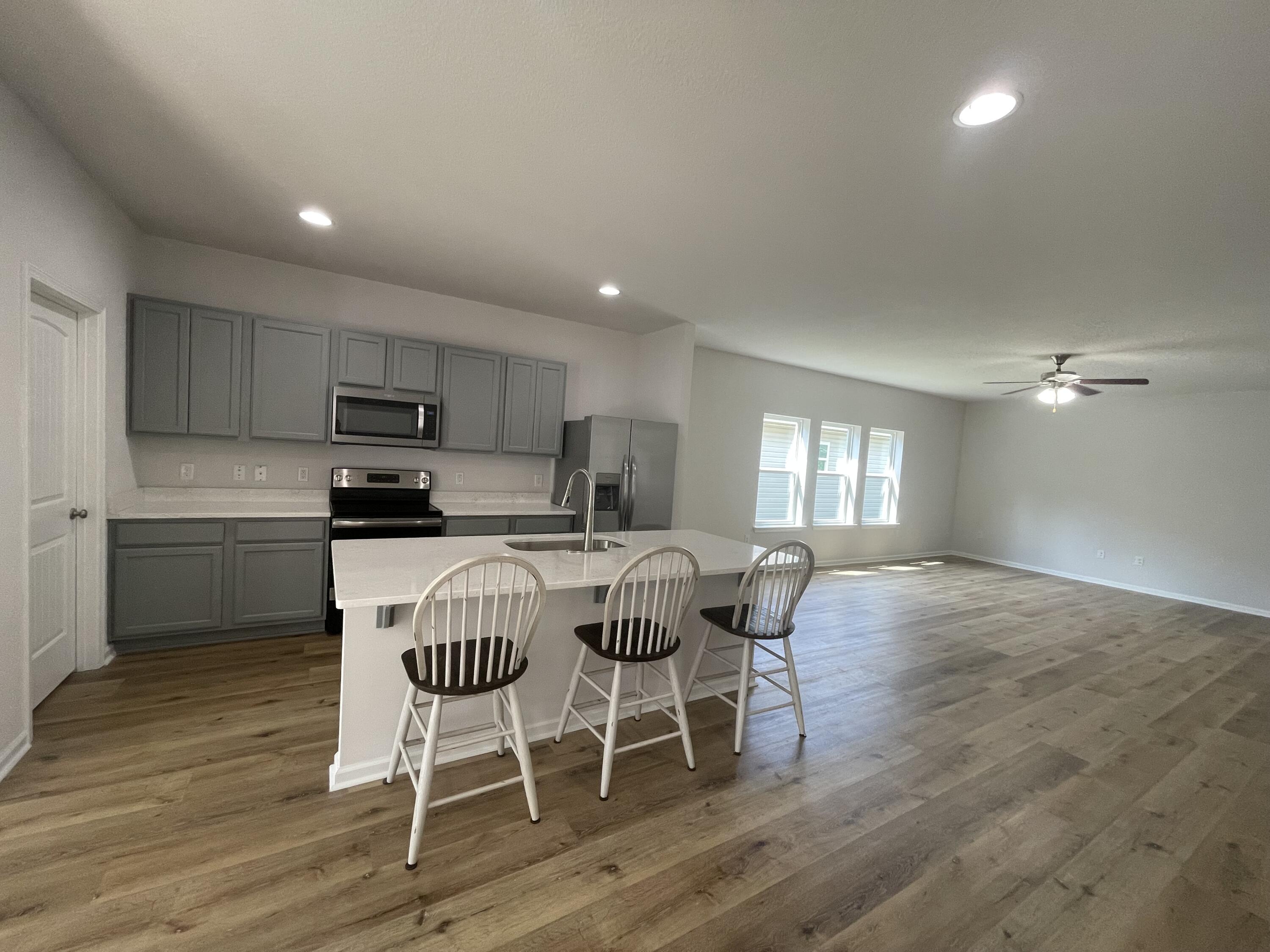 56 Lilly Bell Lane Freeport, FL 32439 - Photo 14 of 20 a view of a dining room with furniture and wooden floor