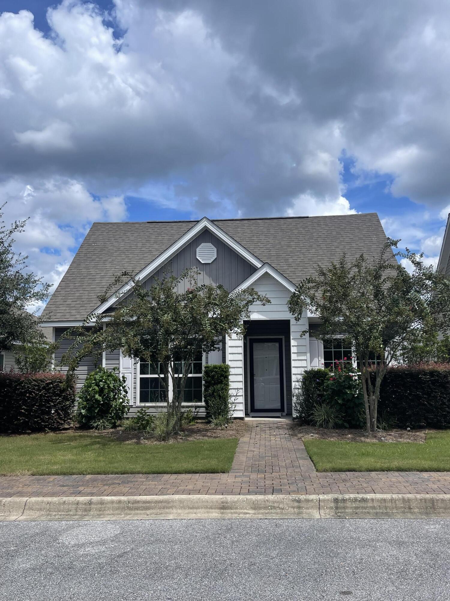 56 Lilly Bell Lane Freeport, FL 32439 - Photo 16 of 20 a view of a big house in front of a big yard with plants and large trees