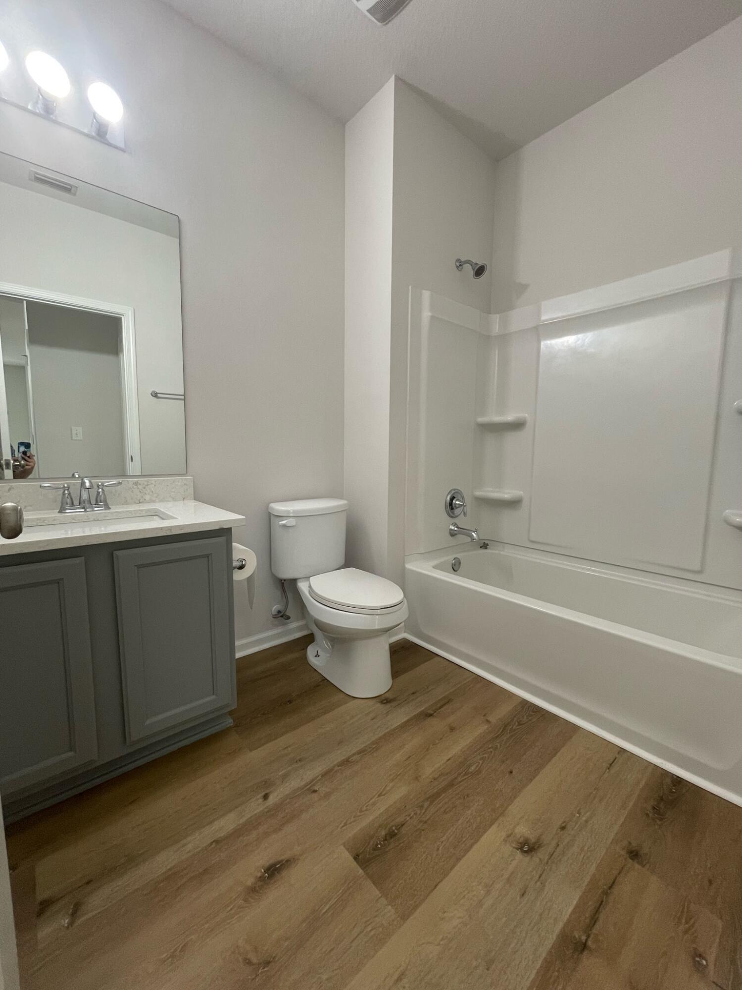 56 Lilly Bell Lane Freeport, FL 32439 - Photo 9 of 20 a bathroom with a sink a toilet and a mirror