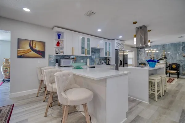 a kitchen with stainless steel appliances kitchen island granite countertop a sink and cabinets