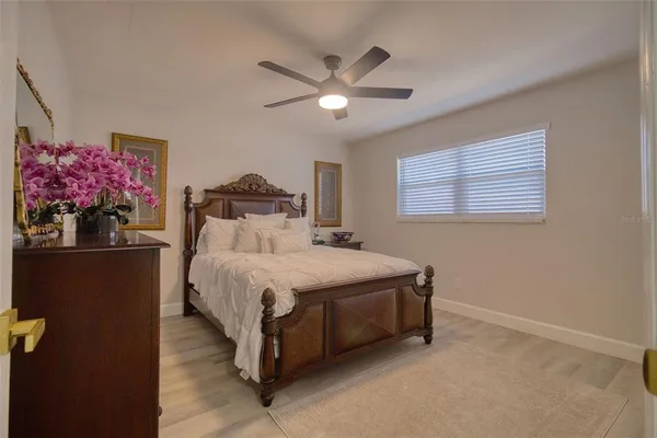 a bedroom with a bed and a chandelier
