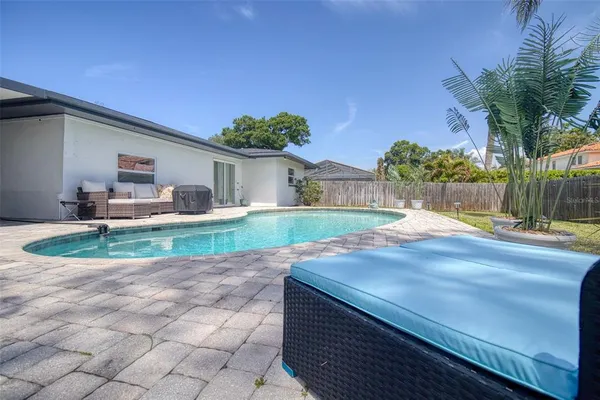a view of a house with backyard and sitting area