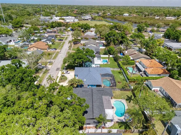 a house view with swimming pool and trees in the background