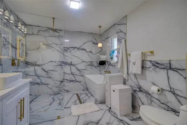 a bathroom with a sink toilet and shower