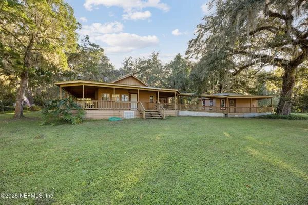 a view of a house with a backyard