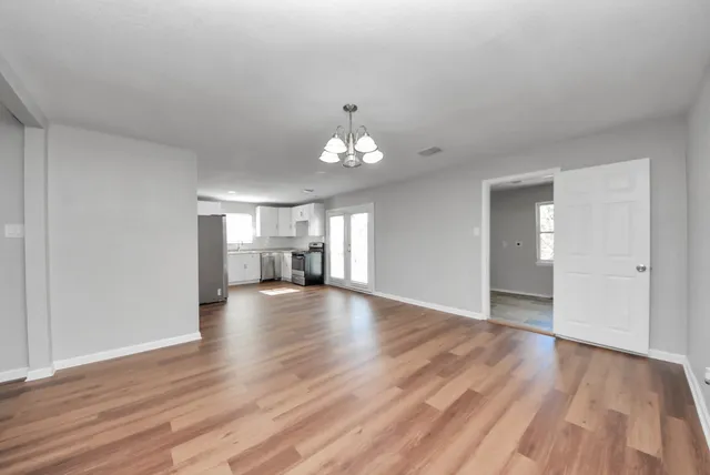 wooden floor in an empty room with a window