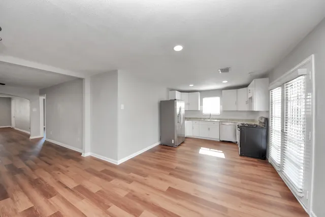 a view of a kitchen with a sink and a refrigerator