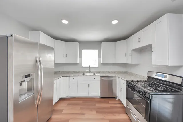 a kitchen with a sink stove and refrigerator