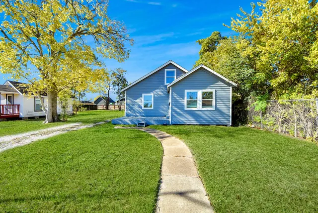 a front view of a house with a yard