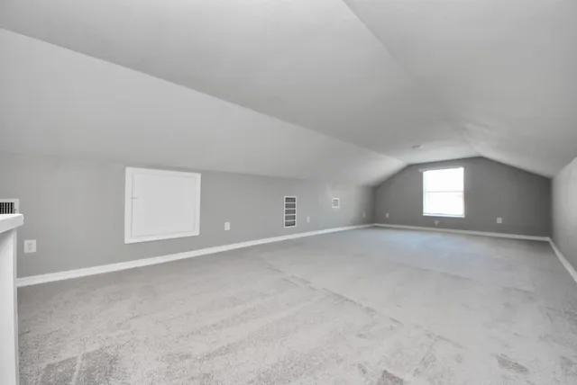 a view of an empty room and a window